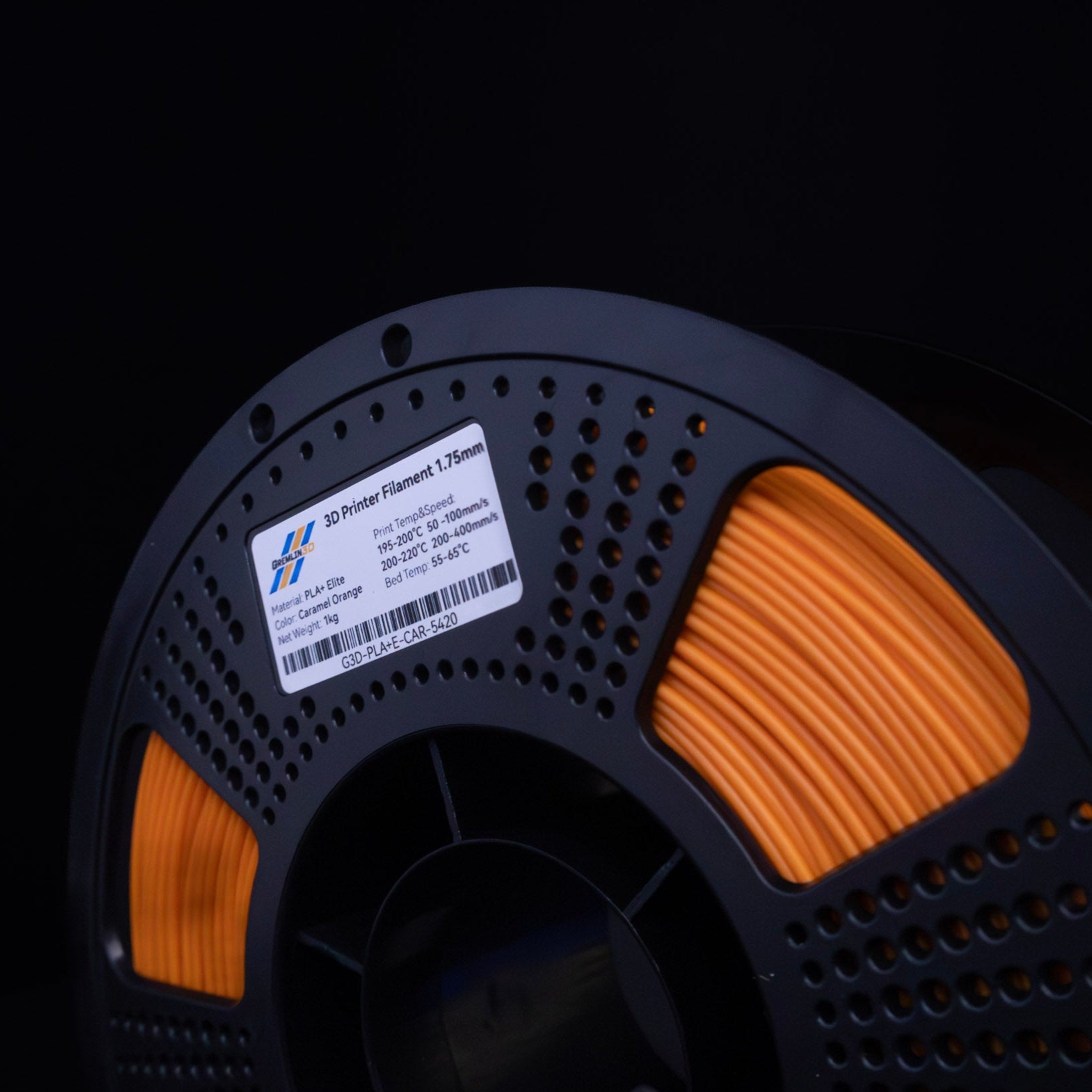 1kg 1.75mm Spool of 3D printing Caramel Orange PLA Plus filament with a visible brand label on a black background
