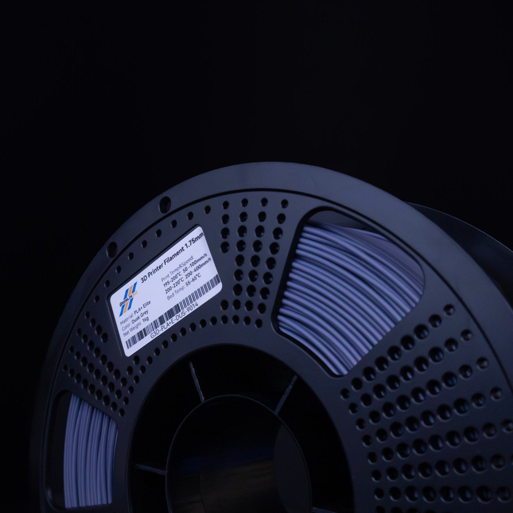 Spool of 3D printing Dusk Grey PLA Plus filament with a visible brand label on a black background