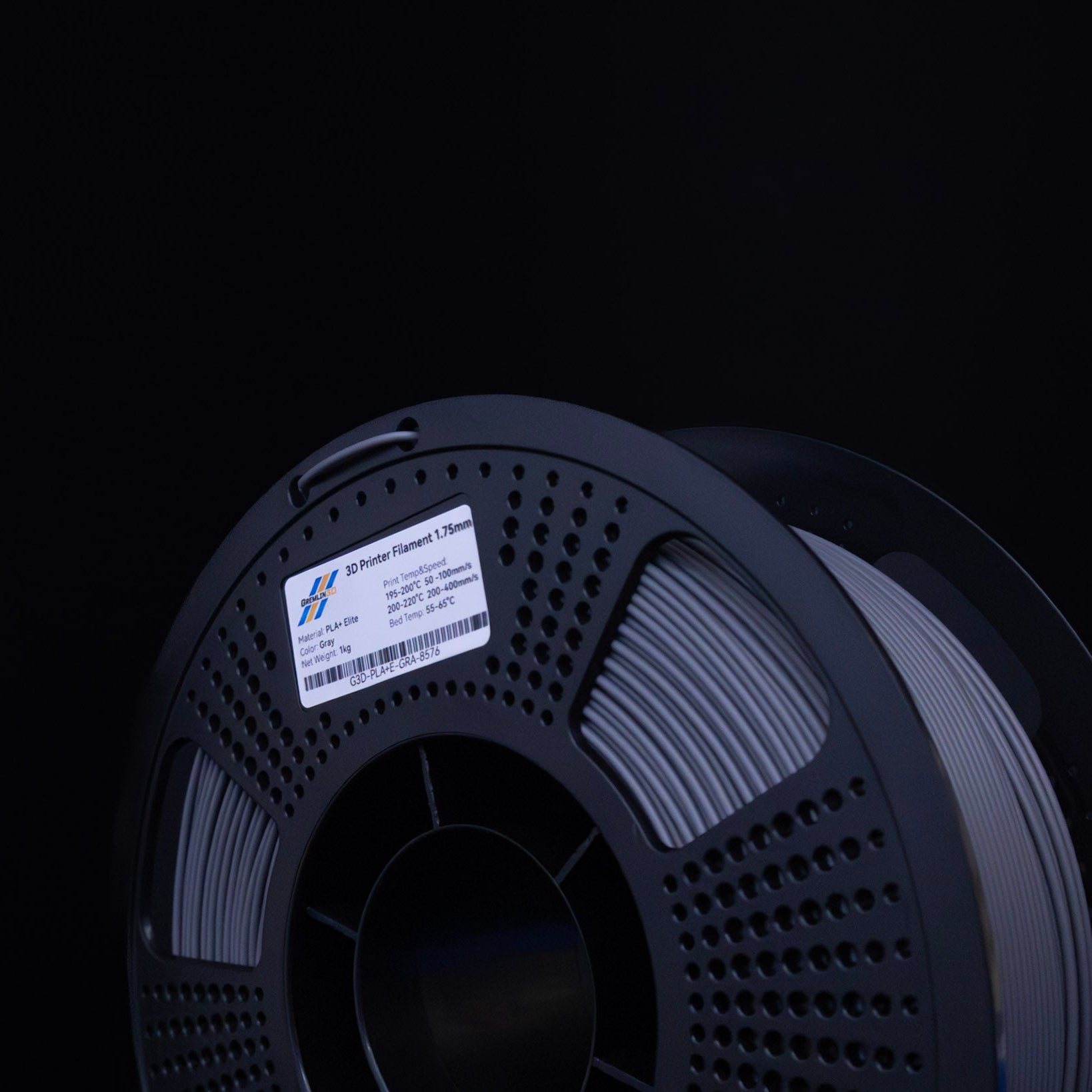 Spool of 3D printing grey PLA Plus filament with a visible brand label on a black background