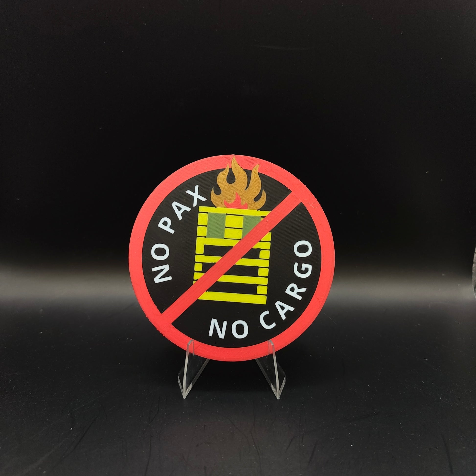 Round hazard sign patch with 'No PAX No Cargo' text and symbol on a black background